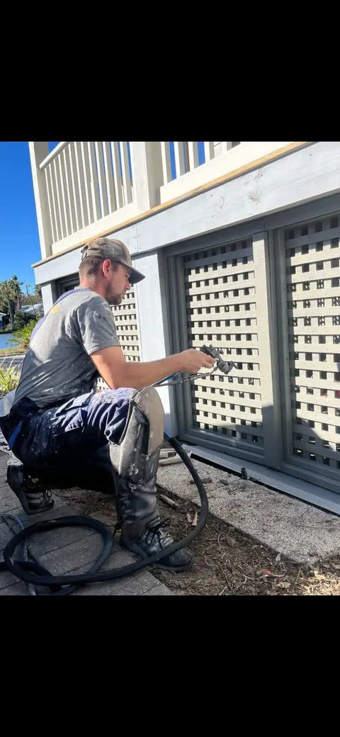 Person using tools wearing self supporting knee pads with removable shin guards, waterproof and washable with built in tool pouches.