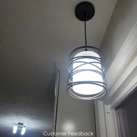 Sleek Modern Mini Pendant Light For Kitchen Island And Dining Room With 6.3 Inch Matte Black Spiral Cage And Handblown Frosted Glass Shade Adjustable Cord 1 Pack illuminated in home setting