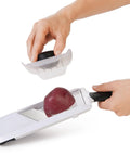 Handheld Mandoline Slicer For Kitchen With Adjustable Slices In 1mm 2.5mm 4mm, Secure Non Slip Handle, slicing a potato