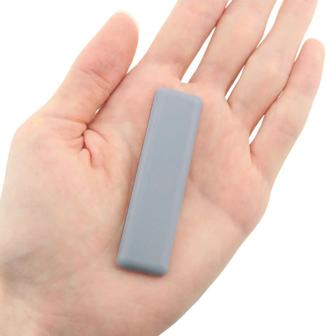 Eight Pack 70x19mm Rectangular PTFE Furniture Sliders With Self Adhesive Backing Heavy Duty Floor Protectors in a hand.