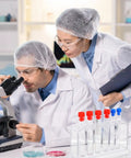 Scientists using a microscope next to Clear Plastic Test Tube Rack For Lab And Classroom Use Holds Multiple Tubes With Color Caps.