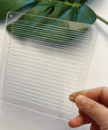 Straight Up Reliable Acrylic Sashiko Stencil For Quilting And Embroidery Crafts 2Mm Thick reusable template held above a plant.