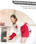 Woman placing food in oven, wearing red apron, showcasing use of 10 Pack Mica Insulation Sheets 150x120mm Microwave Mica Plates