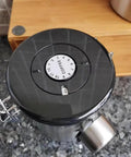 Rock Solid 304 Stainless Steel Coffee Canister Featuring One Way Degassing Valve And Rotatable Date Tracker on countertop.