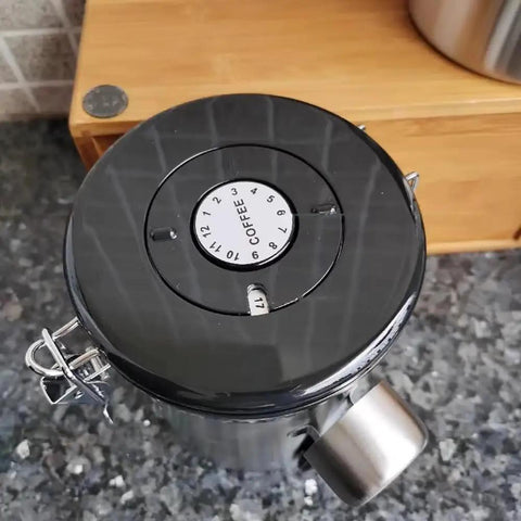 Rock Solid 304 Stainless Steel Coffee Canister Featuring One Way Degassing Valve And Rotatable Date Tracker on countertop.