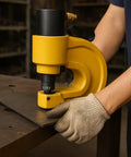 Person using 30 Piece Hydraulic Hole Punch Die Set For CH70 And CH70L with heavy-duty chrome steel dies on metal sheet.
