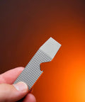 Ultra Slim Pry Bar Keychain Tool Pocket Titanium Multitool for Everyday Carry held against orange background