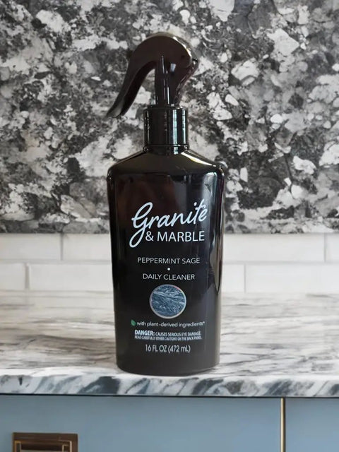 Bottle of Daily Stone Cleaner Spray For Granite, Marble And Quartz With Peppermint Sage Scent on counter, 16 oz