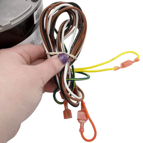 Hand holding wires of Condenser HVAC Motor 1/6 HP, 1 Phase, 208/230V, 825 RPM Replacement With Included Run Capacitor