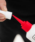 Close-up of All In One Floor Repair Adhesive For Loose Hollow Tiles And Creaky Wood From A Simple Squeeze Tube With Precision Tip Drill And Fill