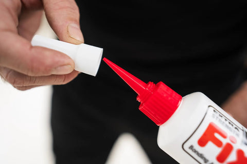 Close-up of All In One Floor Repair Adhesive For Loose Hollow Tiles And Creaky Wood From A Simple Squeeze Tube With Precision Tip Drill And Fill