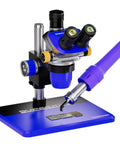 Blue digital microscope with soldering iron on stand next to PCB, used for detailed inspection and repair tasks.