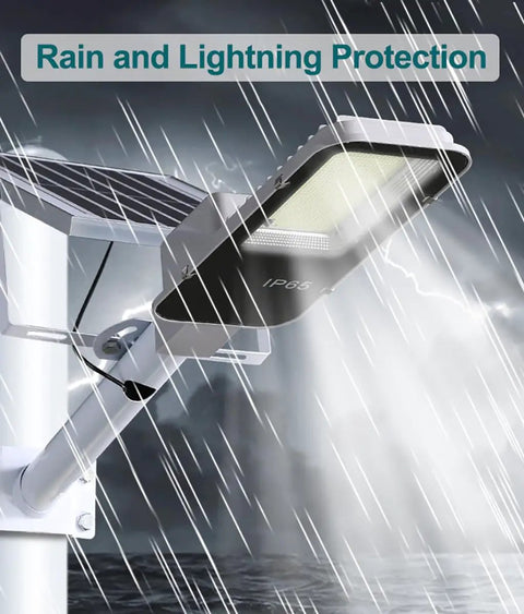 JUDYSSY 150W Solar Street Lights Outdoor with 600 Led Bright Lamp demonstrating IP65 waterproof protection in rain.