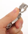 Close-up of heavy duty stainless steel fencing wire clamp in hand for foil cord, durable for training and competition use.