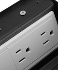 Heavy Duty Pop Up Floor Power Outlet Featuring Double Three Prong Sockets And Brushed Silver Stainless Steel Housing, top view.