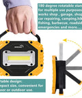 Portable LED Work Light Two Pack Beast Bright AA Battery Powered Flood Lights With COB Chips ultra bright lamp being held.