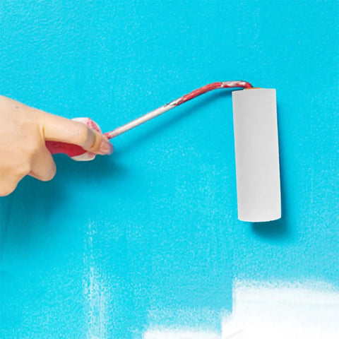 Person using a 6 Piece Paint Roller Set Boasting Hella Soft Sponge Covers And Comfort Grip Handles on blue wall.