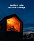 House with glowing orange light at night from Black Light 23 Watt Spiral CFL Bulbs 120V E26 Base UL Approved Energy Saver Pack of 4.