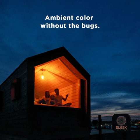 House with glowing orange light at night from Black Light 23 Watt Spiral CFL Bulbs 120V E26 Base UL Approved Energy Saver Pack of 4.