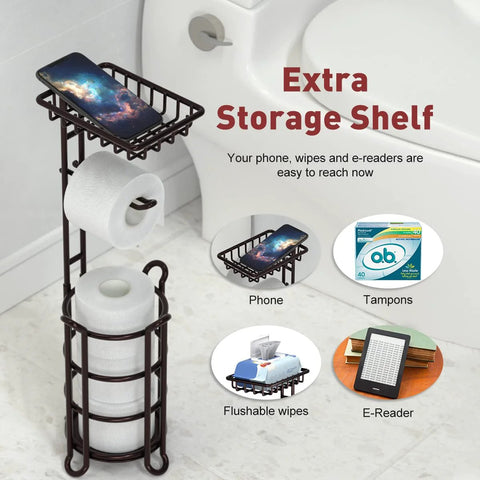 Free Standing Toilet Paper Holder Stand Dispenser With Top Shelf For Bathroom Storage, Bronze Finish, next to a toilet