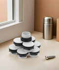 Heavy-Duty Plastic Push Button Switch Hole Plugs Pack 50, white and black panel hole plugs stacked on a table