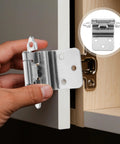 Close-up of chrome-plated self-closing inset cabinet hinge held by hand; circular inset shows hinge mounted on a door.