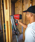 Worker using 33 Degree Paper Tape Framing Nails, 3 1 Quarter Inch Length, 0.131 Inch Ring Shank, Offset Round Head in construction
