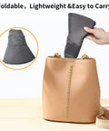 Go To Sun Hat For Men And Women With UPF 50 Plus Protection being folded and placed in a beige bag, illustrating portability.