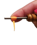 Hand holding Pro Grade Quilling Tool Kit with slotted winding pin for paper bead rolling, features solid wood handle and stainless steel pin
