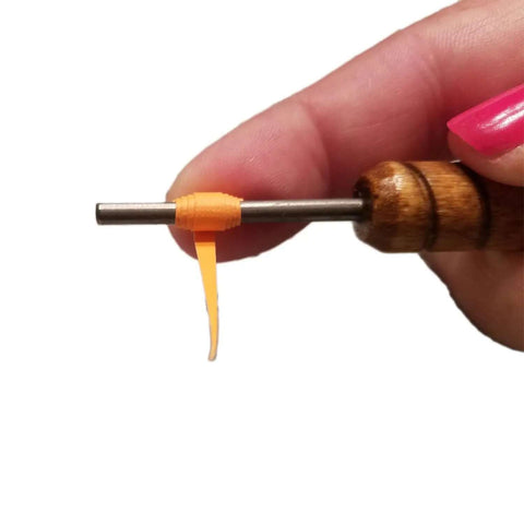 Hand holding Pro Grade Quilling Tool Kit with slotted winding pin for paper bead rolling, features solid wood handle and stainless steel pin