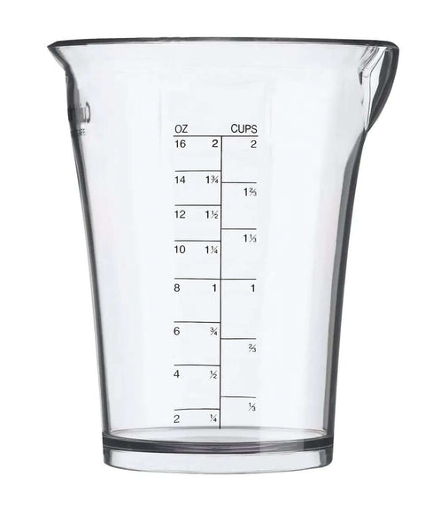 Badass Kitchen Efficiency Delivered By This Lightweight Immersion Hand Blender Featuring Dual Speed Settings A Reliable Lock Mechanism And Comfort Grip For Zero Hassle Blending in a clear measuring cup.