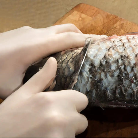 Top Notch Latex Disposable Gloves With Corn Starch Powdered Finish For Food Handling And Light Industrial Chores Smooth As Butter X Large being used to fillet a fish.