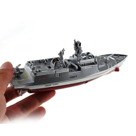 Hand holding Military RC Warship Boat With 2.4 GHz Remote Control Realistic Navy Vessel Toy, durable silver finish, side view