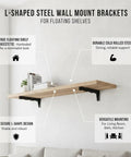 Hidden L Shaped Steel Floating Shelf Bracket in black supporting a wooden shelf with books and decor items in a living room.
