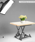 Heavy Duty Electric Lift Table With 250 Lb Capacity Single Scissor Design Foldable Hydraulic Platform Includes Remote Control For Easy Material Transport And Adjustable Height Between Small And Big Jobs with wooden top and flowers.