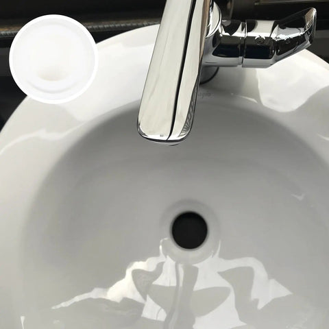 4 Pcs Silicone Bathtub Stopper White Flat Cover Universal Drain Plug beside a shiny chrome faucet above a white sink.