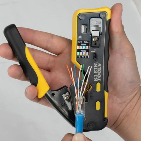 Hand holding tool preparing Modular Data Plug For CAT6A And Thicker CAT6 Cables, No Fuss Fast Pass Thru Install