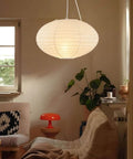 FEHEED 16 Inch Oval Plug in Hanging Paper Lantern Lights with Cord illuminating a cozy living room with couches and plants.