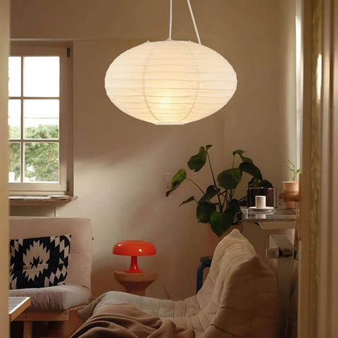 FEHEED 16 Inch Oval Plug in Hanging Paper Lantern Lights with Cord illuminating a cozy living room with couches and plants.