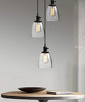 Industrial Pendant Ceiling Light In Black Finish With 5.7 Inch Oval Glass Shade, E26 Socket Compatible, hanging over table