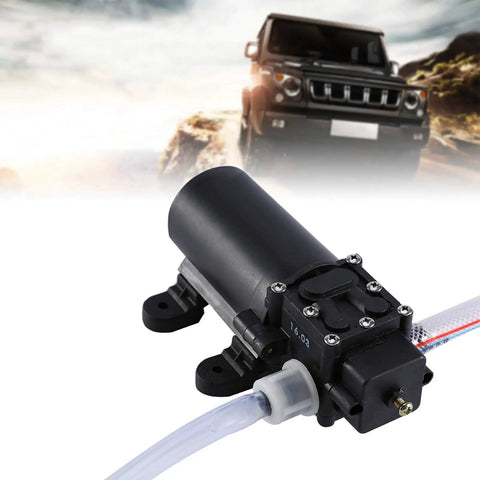 Heavy Duty 12V Auto Car Oil Extraction Pump Kit showing motor and tube for fluid transfer in an outdoor setting.
