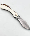 Folding Pocket Knife With 2.99 Inch Damascus Steel Blade And Ivory Synthetic Handle shown closed on white background