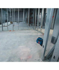 GLL50-RT Self-Leveling Cross Line Laser Renewed projecting lines on concrete floor at construction site, steel framing visible