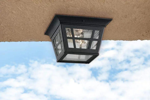Herrington Two Light Outdoor Ceiling Flush Mount Fixture In Black Finish For Patio And Exterior Spaces against sky view