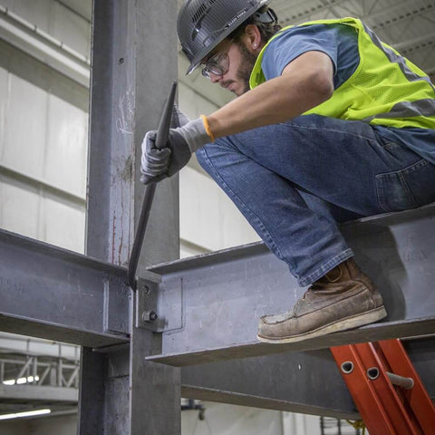 Worker using Ergonomic Round Connecting Bar 7/8 Inch Wide By 30 Inch Long With 15 Degree Angled Chisel, Tapered End For Seamless Bolt Hole Alignment