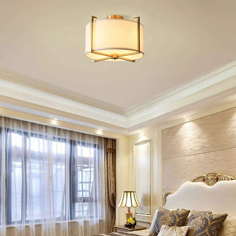 Dope Brushed Brass Four Light Flush Mount Ceiling Light With Drum Fabric Diffuser in elegant bedroom setting