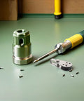 Workbench with various tools including a screwdriver, screws, and a metallic component, suitable for DIY projects.