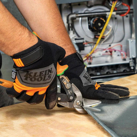 Close-up of Klein Tools 2401R right-cutting offset tin snips with forged blades cutting sheet metal