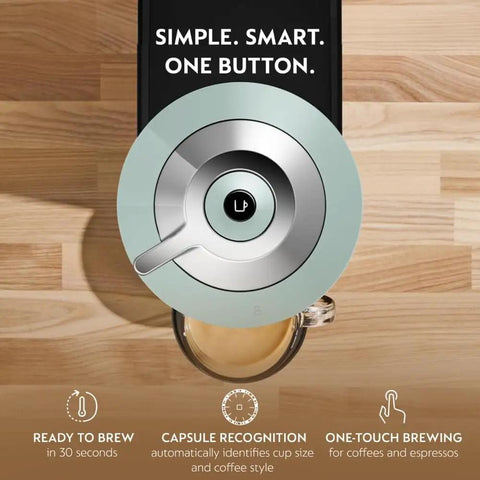 Top view of Vertuo Next Coffee And Espresso Maker By De'Longhi Turn Your Kitchen Into A Local Coffee Shop With Fast Heat Up Crema Rich Brew Coffee Or Espresso In One Go Multiple Cup Sizes Sleek Compact Design For Everyday Use in Jade color on wooden counter.