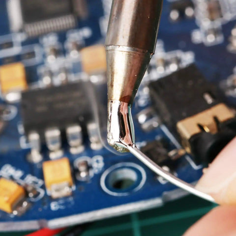 Leaded Solder Wire 0.6mm Sn63Pb37 With Flux Rosin Core For Electronics Soldering 100g Roll in use on circuit board close-up